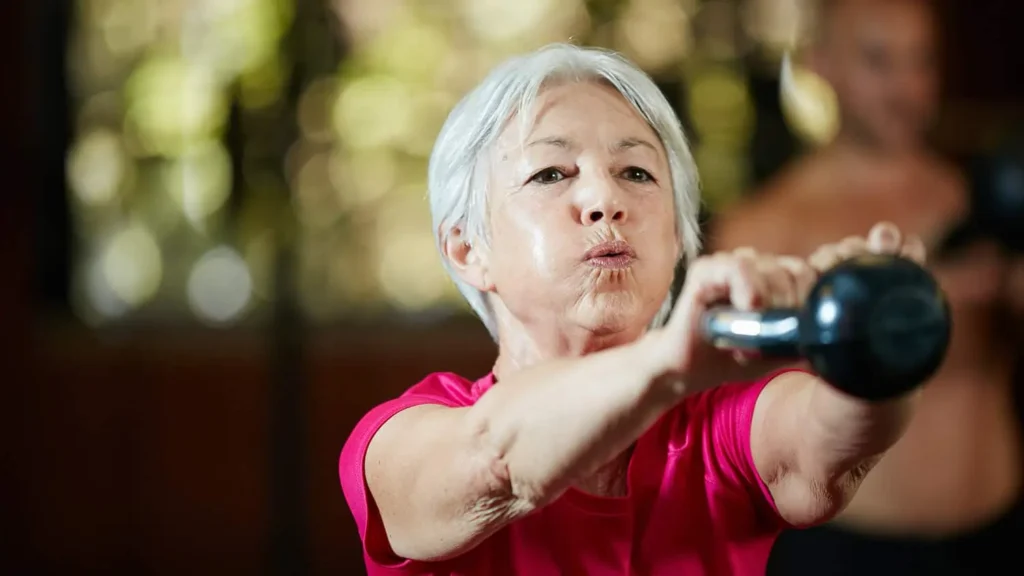 Toning Bingo Wings: Effective Exercises and Tips for Achieving Sleeker Arms 2 Person performing arm exercises with dumbbells Burgess Hill